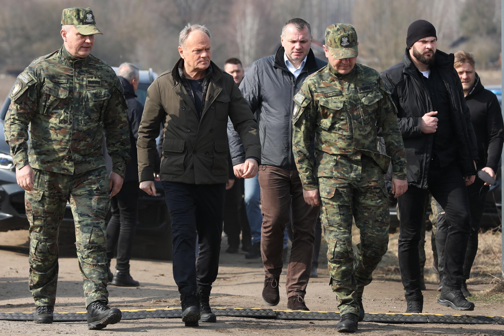 El Primer Ministro polaco Donald Tusk (2-I) y el Comandante en Jefe de la Guardia de Fronteras, el Mayor General Robert Bagan (I) en la frontera estatal polaco-bielorrusa en Ozierany Male, en el este de Polonia, 22 de marzo de 2025. (Polonia) EFE/EPA/Artur Reszko POLONIA FUERA