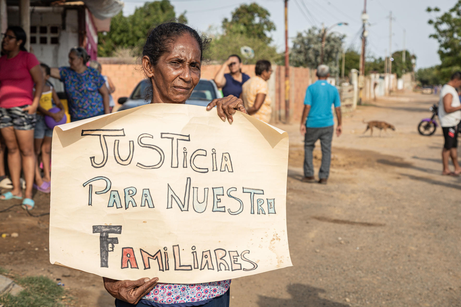Una mujer sostiene un cartel durante una protesta de familiares de un grupo de migrantes venezolanos que fueron deportados desde Estados Unidos hasta El Salvador. EFE/ Henry Chirinos