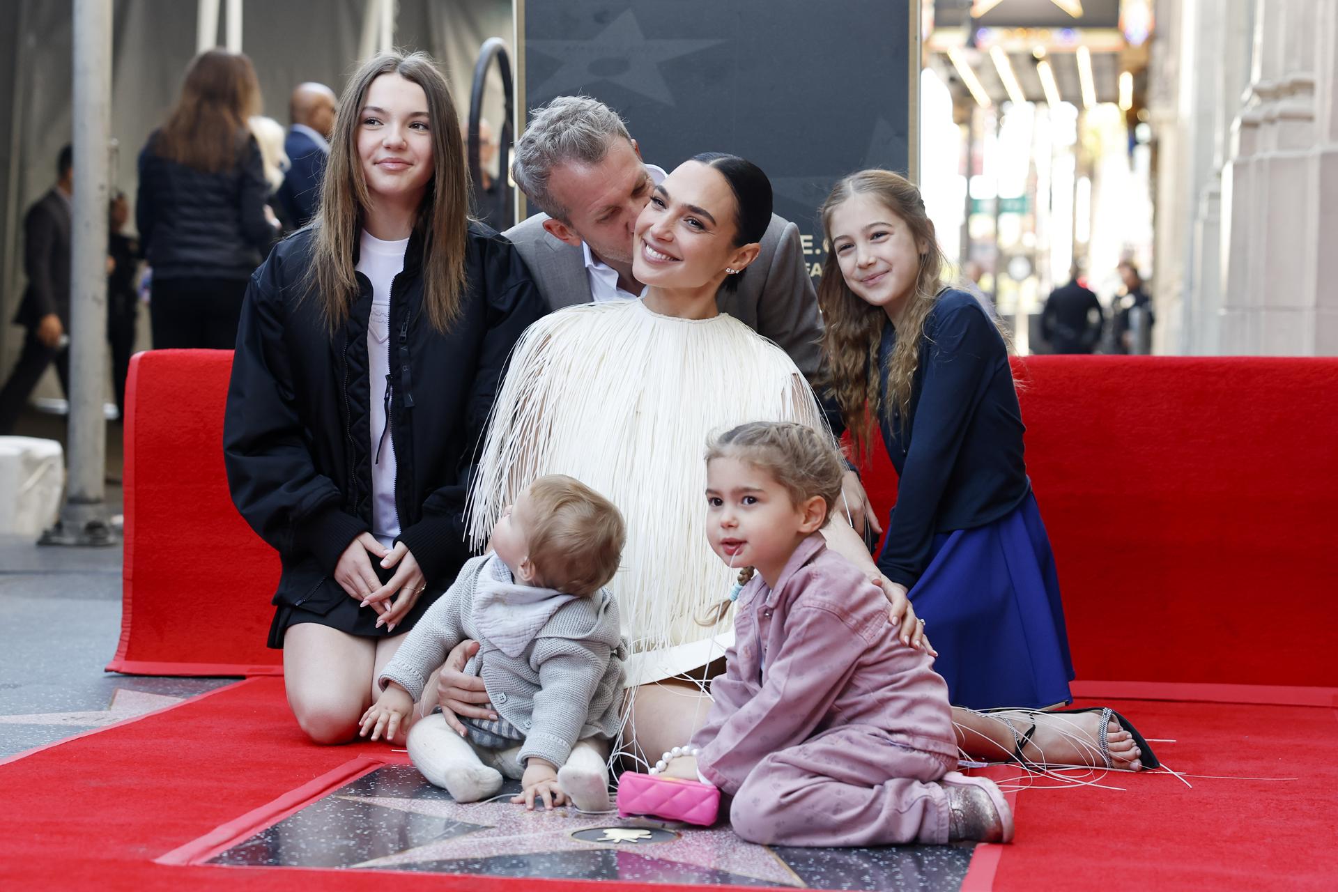 La actriz israelí Gal Gadot (C) posa con su familia (fondo, de izquierda a derecha) Alma Varsano, su esposo Jaron Varsano, Maya Varsano y Ori Varsano (frente-I) y Daniella Varsano (frente-D) junto a su estrella recién inaugurada en el Paseo de la Fama de Hollywood durante una ceremonia en su honor en Los Ángeles, California, EE. UU., el 18 de marzo de 2025. EFE/EPA/CAROLINE BREHMAN