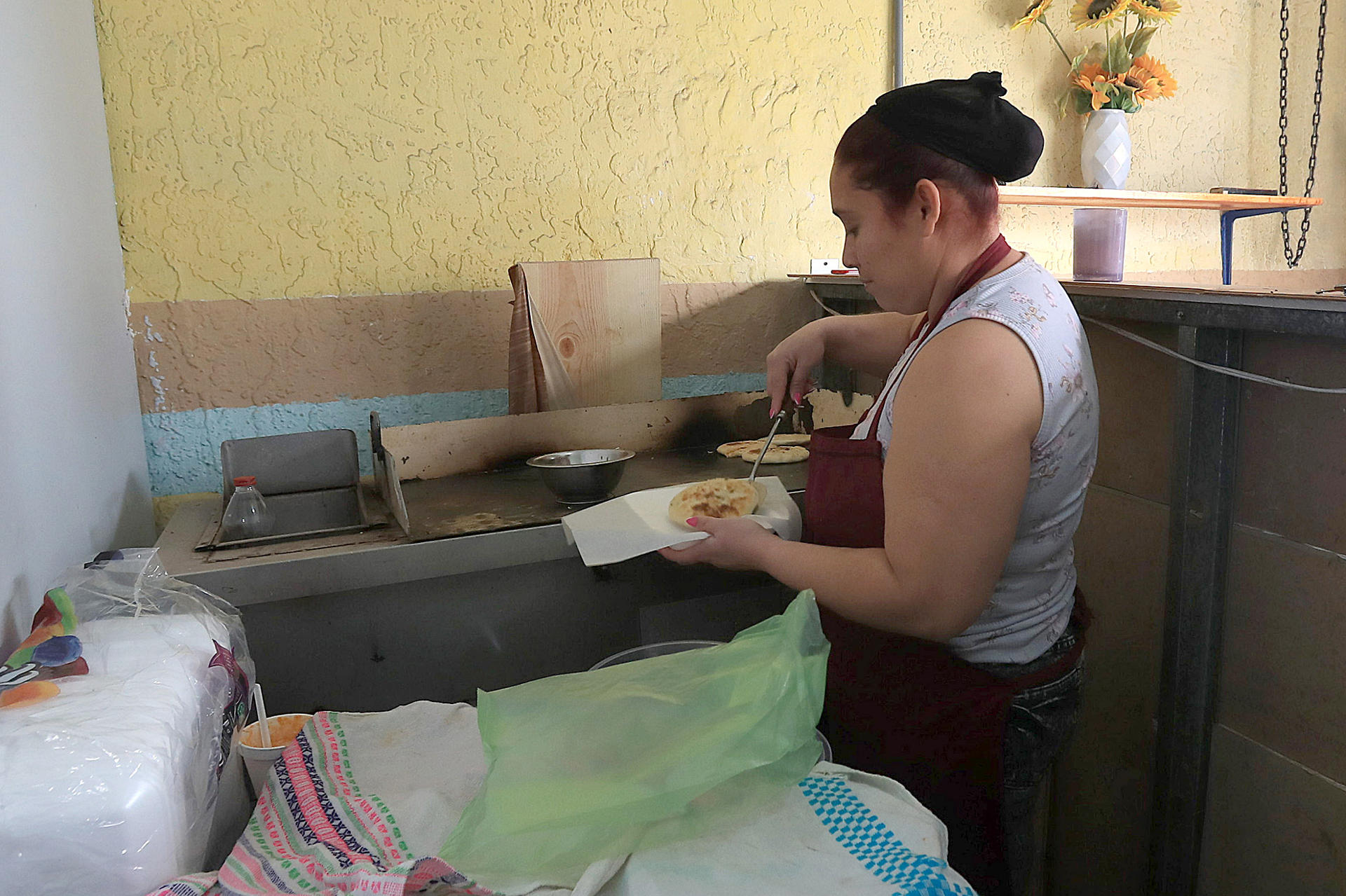 Karla García, migrante de origen salvadoreña atiende un negocio de comida este martes en Ciudad Juárez (México). EFE/ Luis Torres