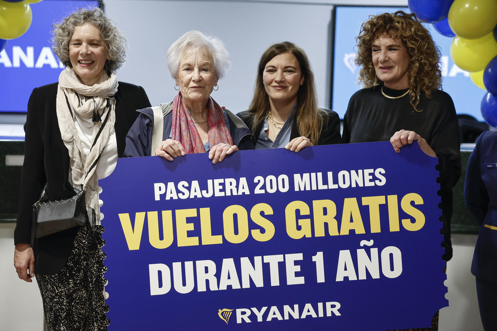La pasajera número 200 millones de pasajeros Miecke Boss (2i), posa con el premio Ryanair para celebrar el hito de alcanzar los 200 millones de pasajeros, este miércoles en el aeropuerto Adolfo Suárez Madrid Barajas.-EFE/ Sergio Pérez