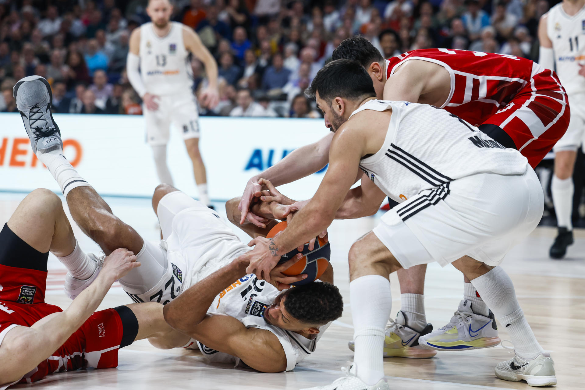 El pívot del Real Madrid Edy Tavares (c) lucha con los jugadores del Armani Milán durante el partido de la EuroLiga de baloncesto que Real Madrid y Armani Milán disputaron en el Movistar Arena. EFE/Juanjo Martín