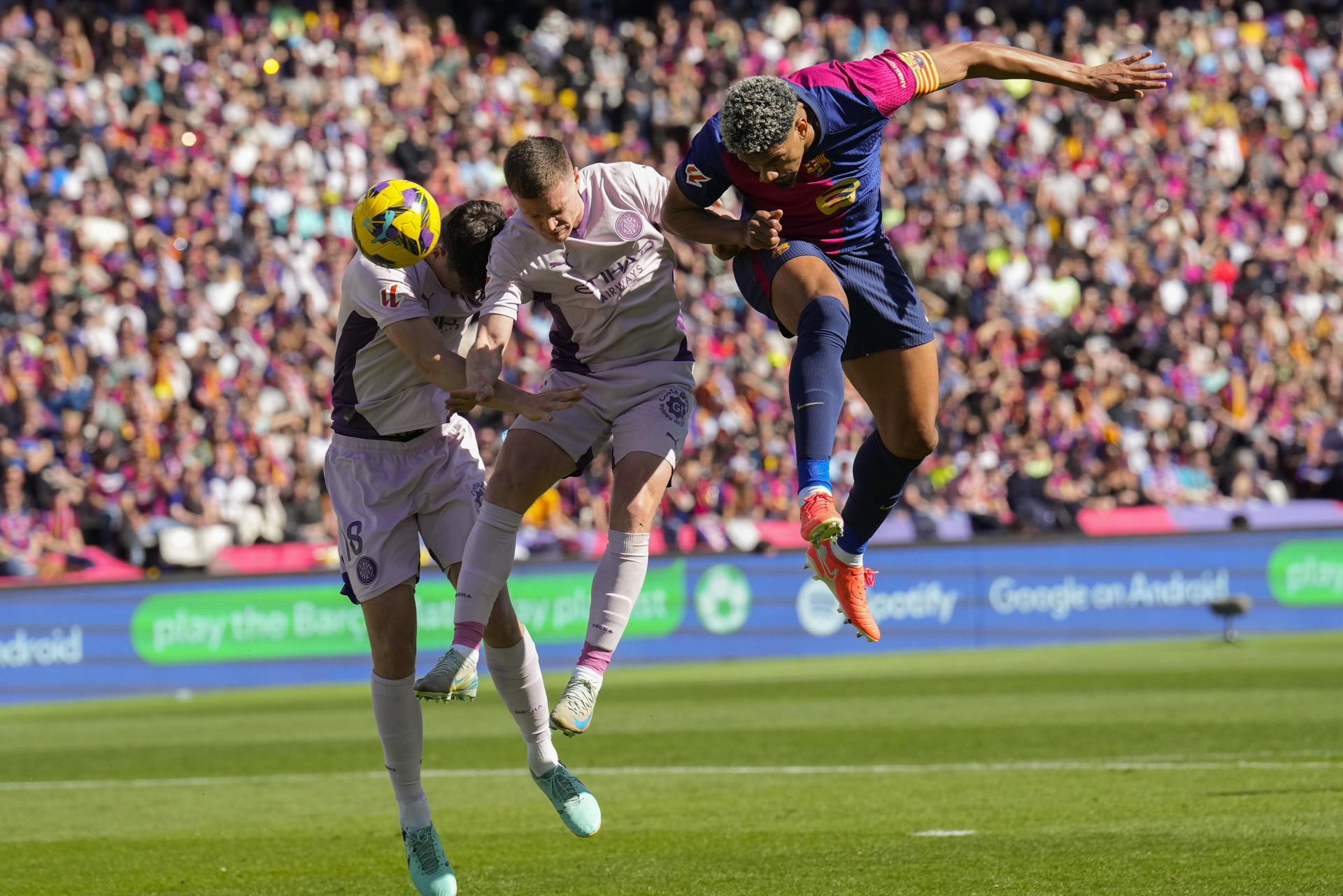 El defensa del Barcelona Ronald Araujo, el defensa del Girona Ladislav Krejci y el centrocampista del Girona Viktor Tsygankov, durante el partido de la jornada 29 de LaLiga que FC Barcelona y Girona disputaron en el estadio Lluis Companys de Barcelona. EFE/ Alejandro García