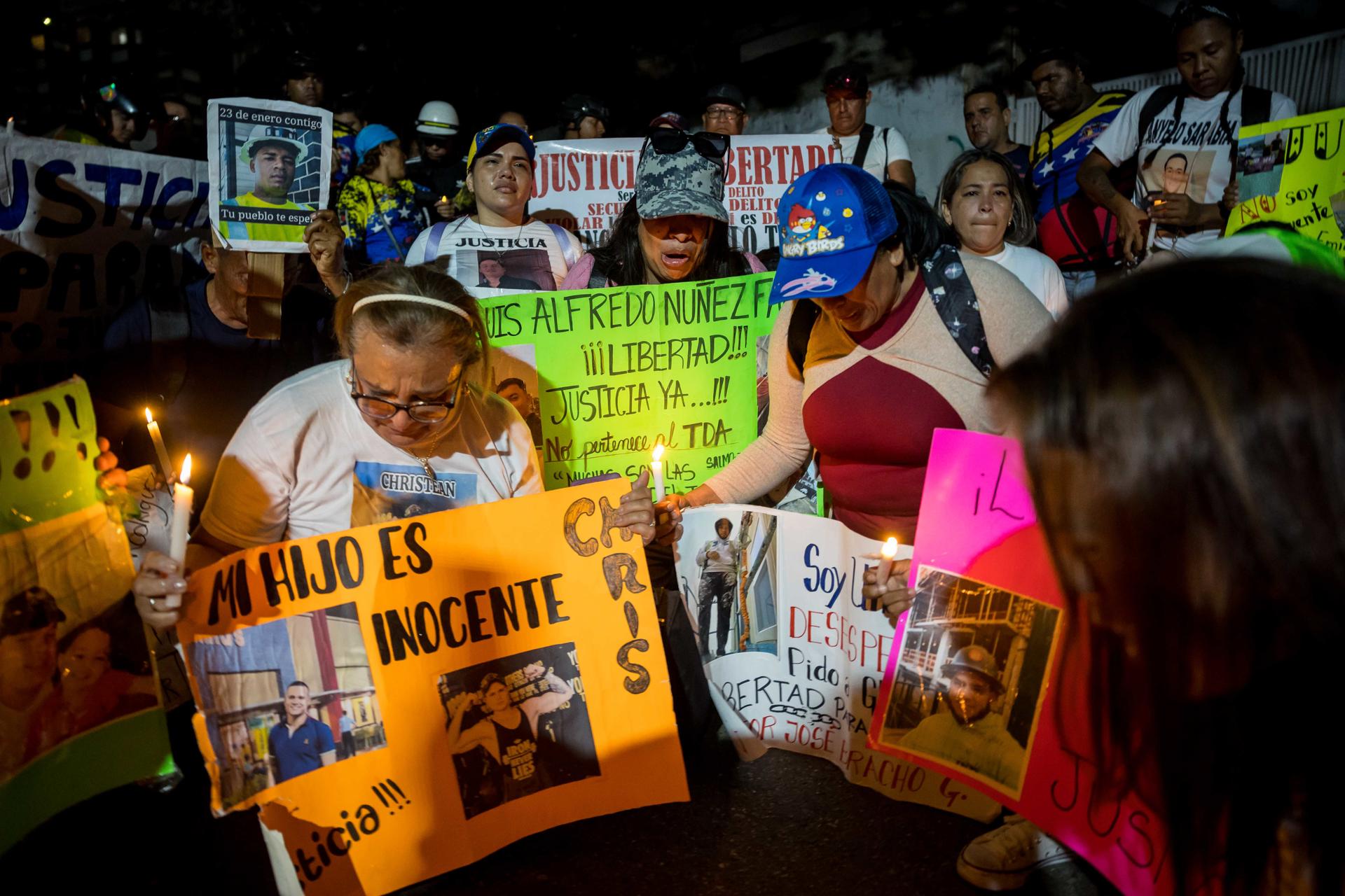 Una mujer sostiene una vela durante una manifestación este miércoles, frente a la sede diplomática de El Salvador, en Caracas (Venezuela). EFE/ Miguel Gutiérrez