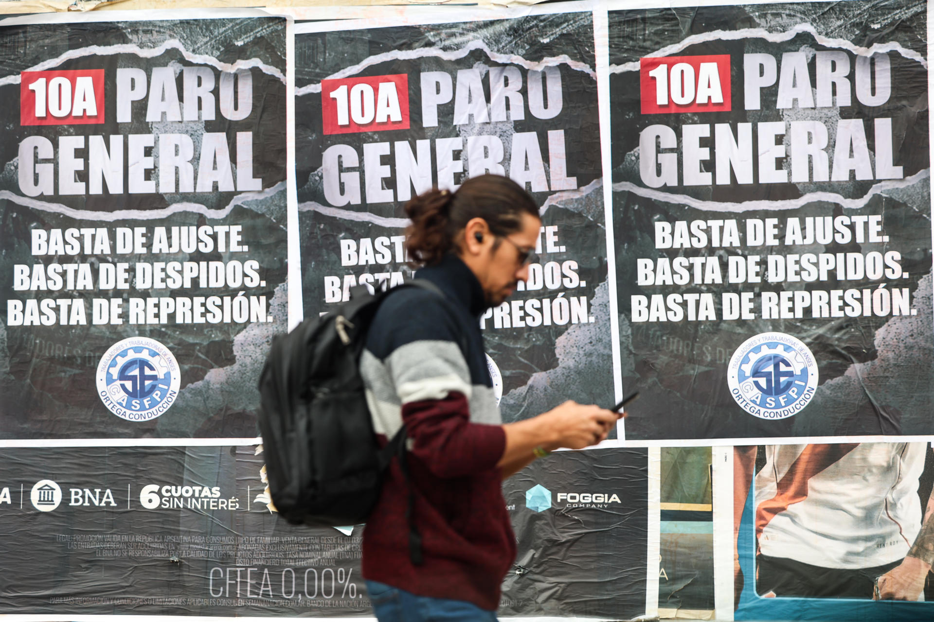 Una persona camina frente a carteles que anuncian el paro nacional este 10 de abril de 2025, en la ciudad de Buenos Aires (Argentina). EFE/ Juan Ignacio Roncoroni