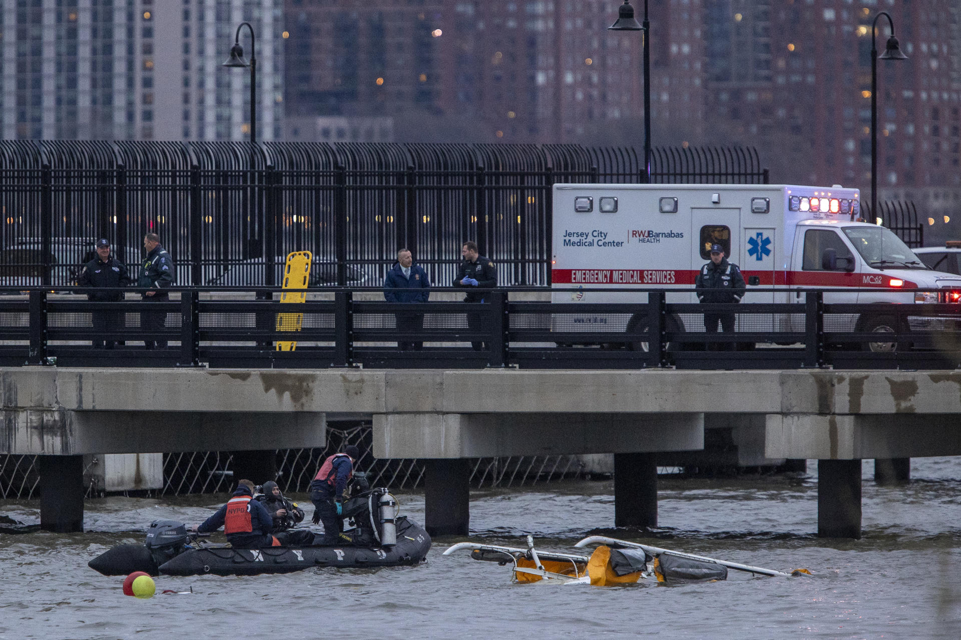 Personal de organismos de emergencia participan en las labores de rescate tras el accidente de un helicóptero este jueves, en el Río Hudson en Nueva York (Estados Unidos). EFE/ Angel Colmenares