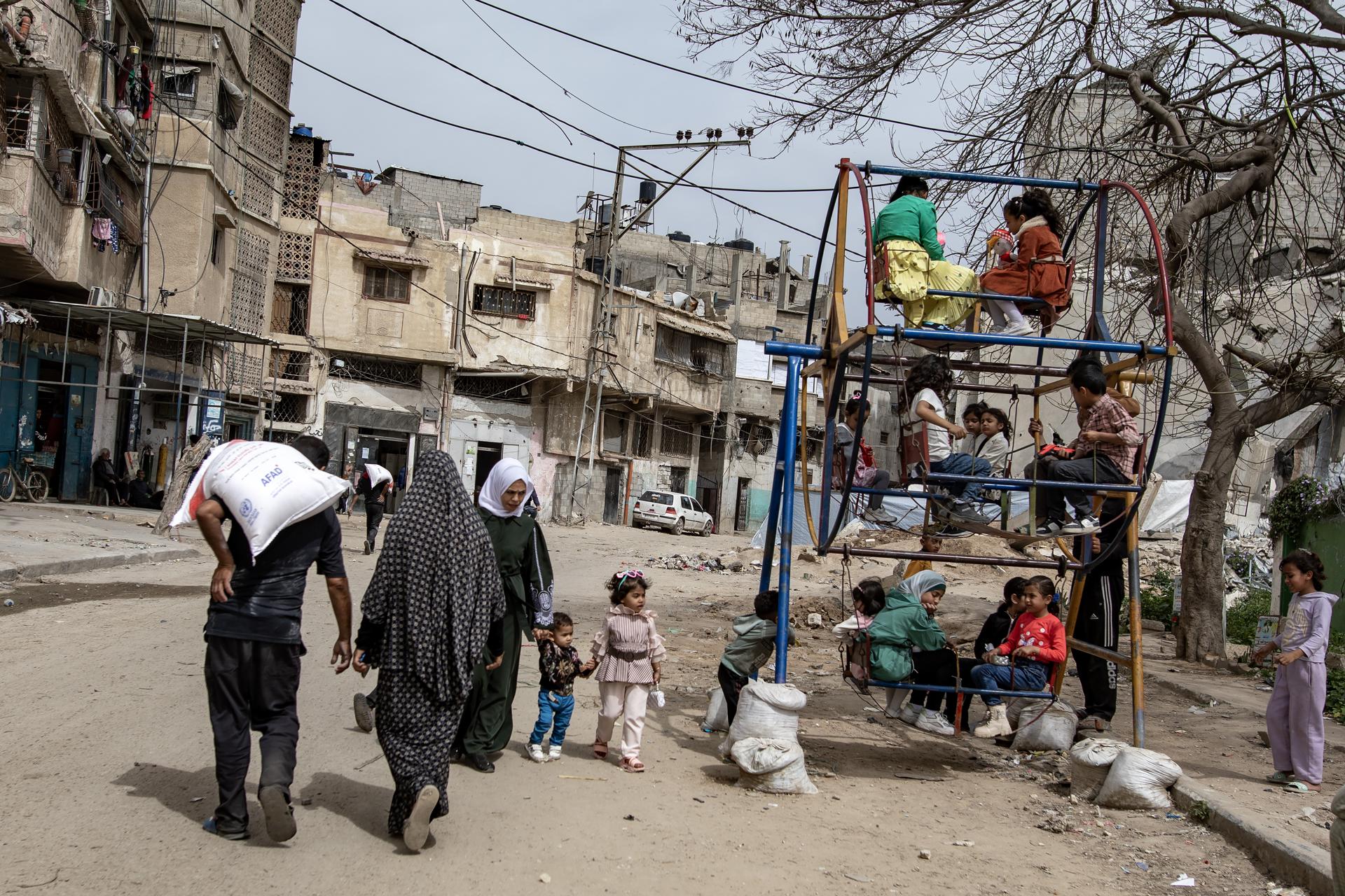 Palestinos desplazados internos transportan sacos de harina después de recogerlos en un punto de distribución, en la ciudad de Gaza, el 1 de abril de 2025. EFE/EPA/HAITHAM IMAD