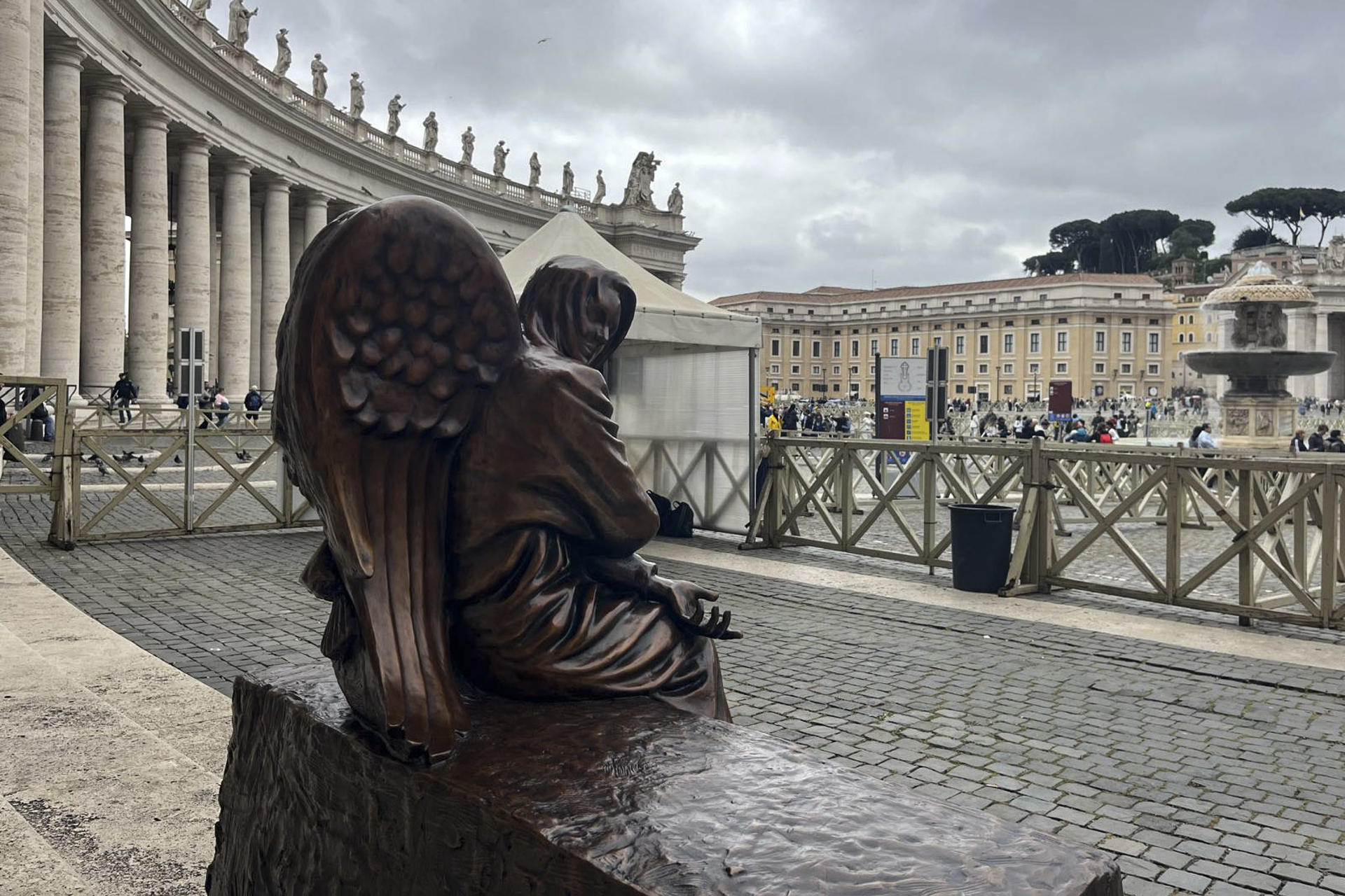 El Vaticano instaló este martes una nueva escultura en la columnata de la Plaza de San Pedro, una pieza de bronce que representa a un ángel oculto en la figura de un sintecho y cuyo título 'Be Welcoming' (Sean acogedores) inspira a la hospitalidad de los más vulnerables. EFE/ Claudia Sacristán