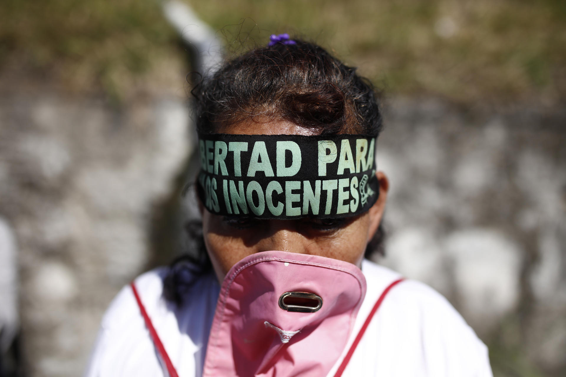 Detalle de la cara de una mujer al protestar, a las afueras del centro penal La Esperanza, para exigir la libertad de presos que consideran inocentes, cerca de San Salvador (El Salvador). EFE/Rodrigo Sura