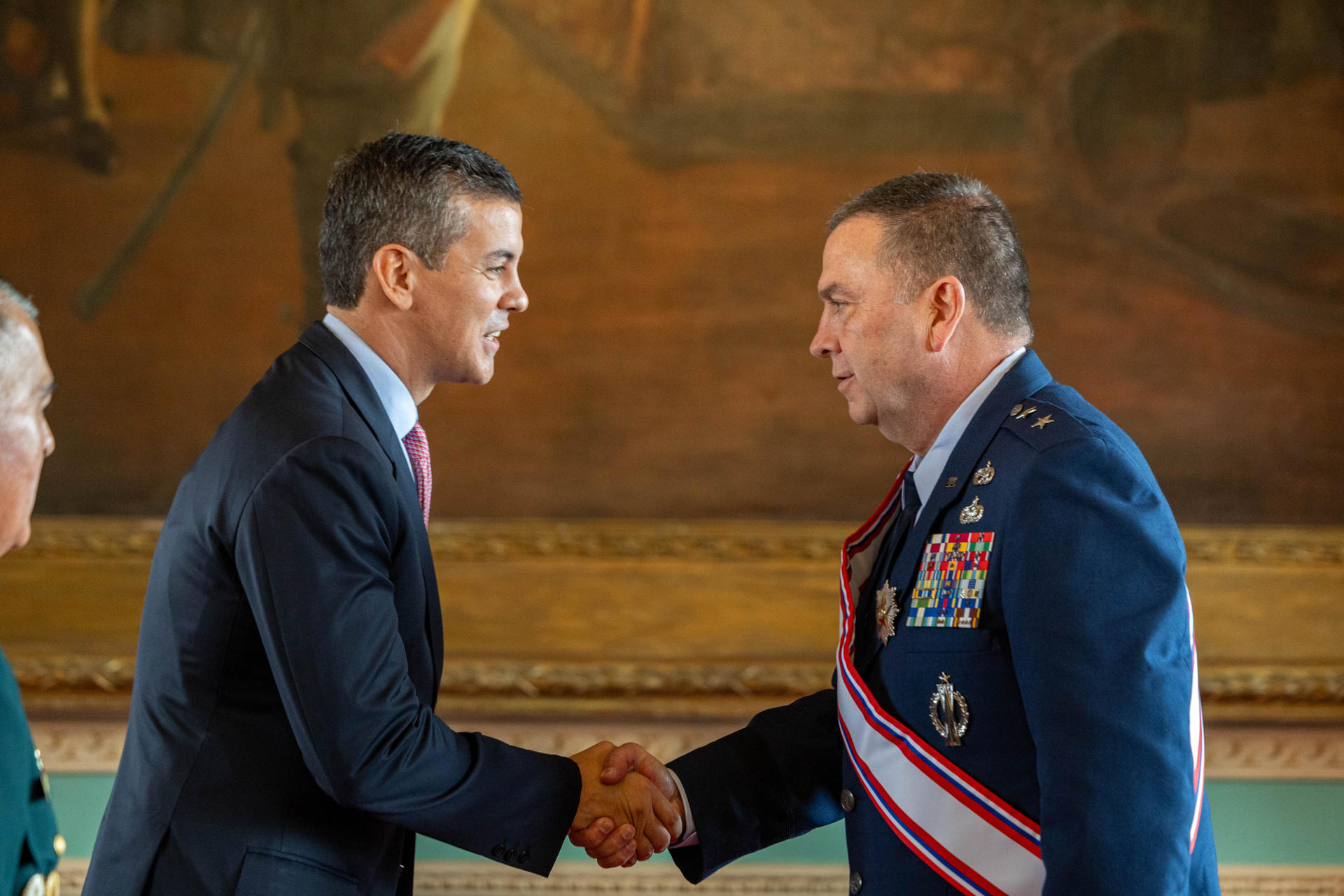 Fotografía cedida por la presidencia de Paraguay del mandatario paraguayo, Santiago Peña (i), saludando al comandante de la Guardia Nacional del estado de Massachusetts (Estados Unidos), Gary Keefe, durante su condecoración con la Orden al Mérito de las Fuerzas Militares de Paraguay ‘General Bernardino Caballero’ en el grado de gran cruz este jueves, en Asunción (Paraguay). EFE/ Presidencia de Paraguay