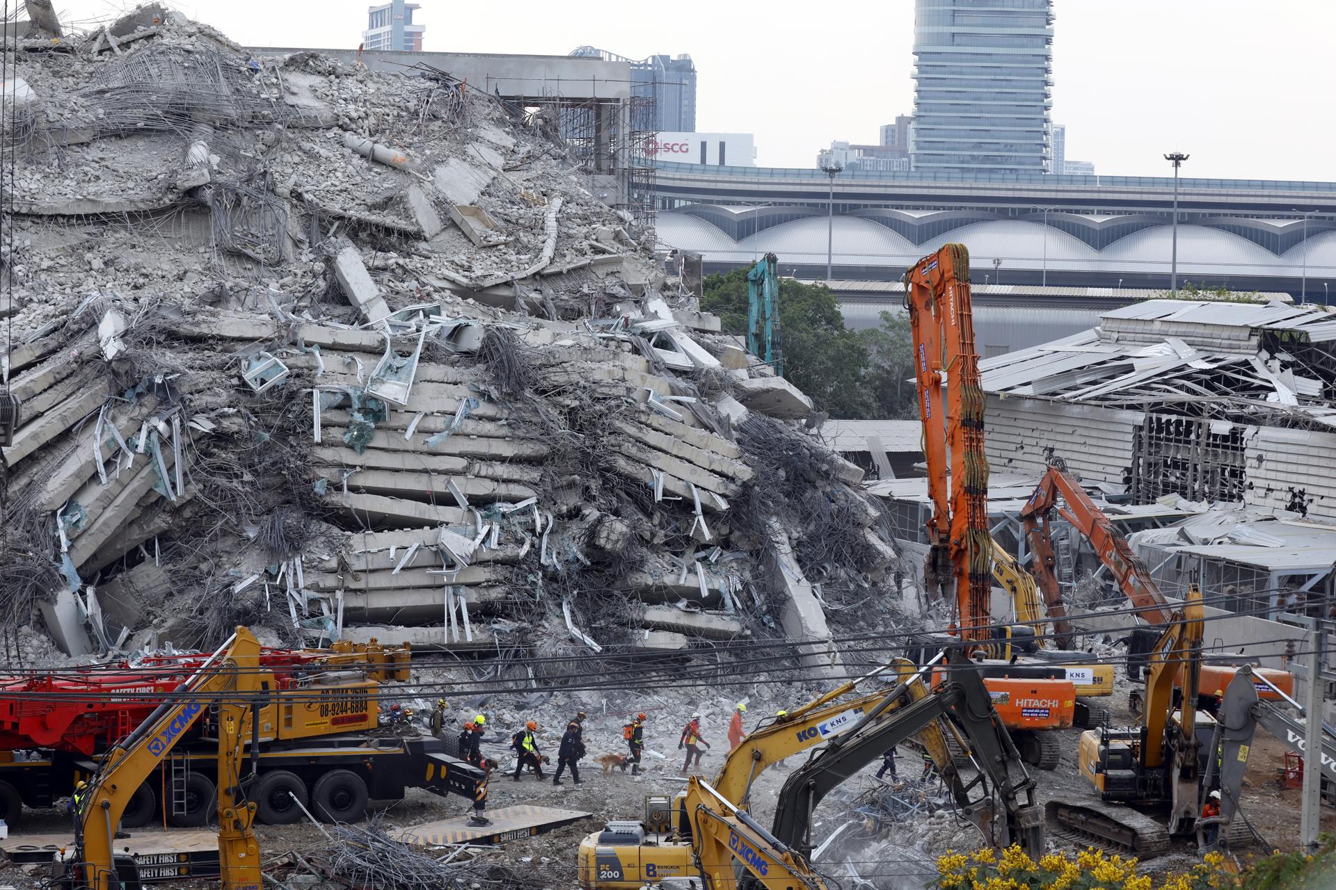 Los rescatistas con perros realizan una operación de búsqueda en el lugar de un edificio que colapsó tras un terremoto en Bangkok, Tailandia, 02 de abril de 2025. Al menos 20 personas han sido confirmadas muertas y 72 permanecen desaparecidas en Bangkok, incluyendo al menos 15 personas que fallecieron tras el colapso de un edificio de 30 pisos debido a los temblores del terremoto de magnitud 7.7 que azotó Birmania, según el Centro de Emergencias Médicas Erawan. (Terremoto/sismo, Birmania, Tailandia) EFE/EPA/NARONG SANGNAK