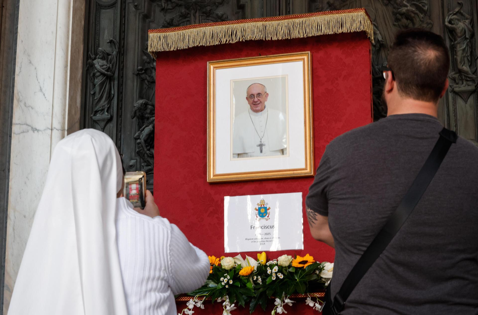 Foto de archivo de gente cerca de una imagen del difunto Papa Francisco en la Basílica de Santa María la Mayor en Roma. EFE/GIUSEPPE LAMI