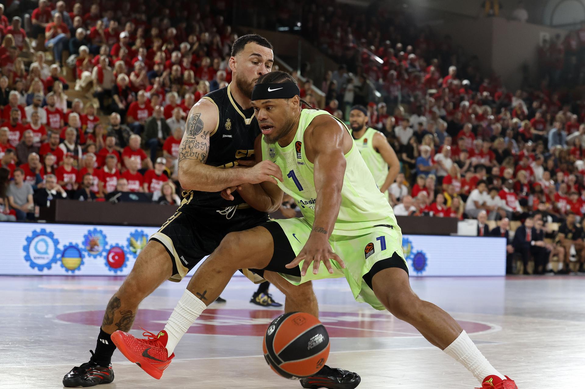 Mike James (i), del Mónaco, pugna con el barcelonista Justin Anderson, en el primer partido de la eliminatoria de cuartos de final de la Euroliga disputado en el estadio Louis II. EFE/EPA/SEBASTIEN NOGIER