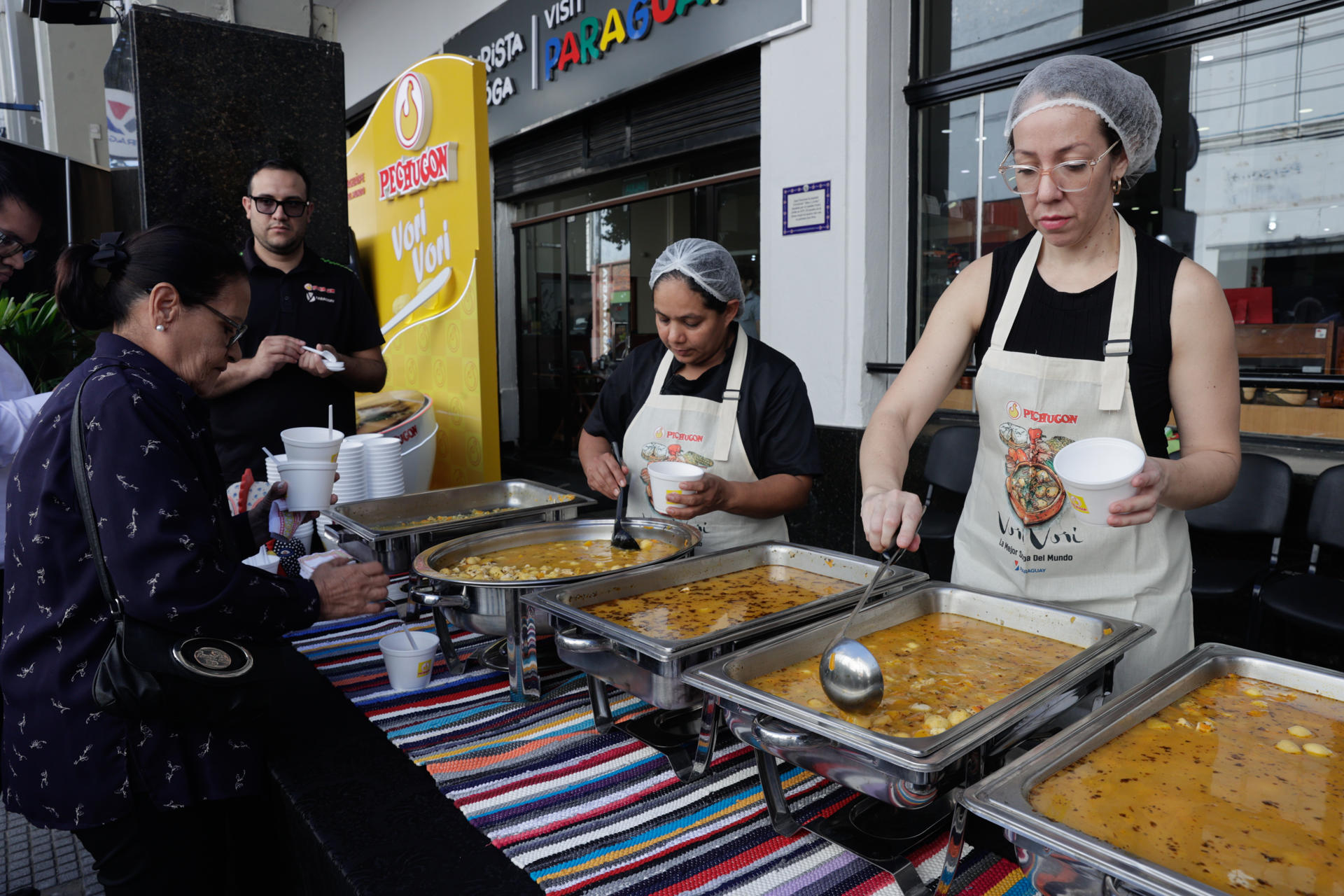 Una cocinera sirve vori vori, un caldo tradicional de pollo y maíz, durante la celebración del Día Nacional de este plato, este lunes en Asunción (Paraguay). EFE/ Juan Pablo Pino