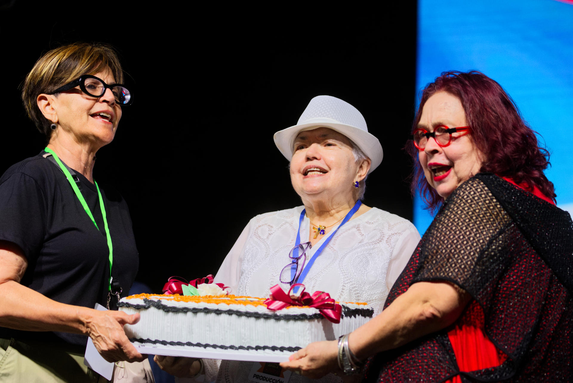 La presidenta del Comité del Festival Claridad, Madeline Ramírez (i), la presidenta de la Junta Directiva de Claridad, Carmen Ortiz Abreu (c), y la directora del periódico Claridad, Alida Millan Ferrer (d), sostienen la torta de cumpleaños de Claridad durante el Festival Claridad celebrado este jueves en el estacionamiento del Estadio Hiram Bithorn en San Juan, Puerto Rico. EFE/Thais Llorca