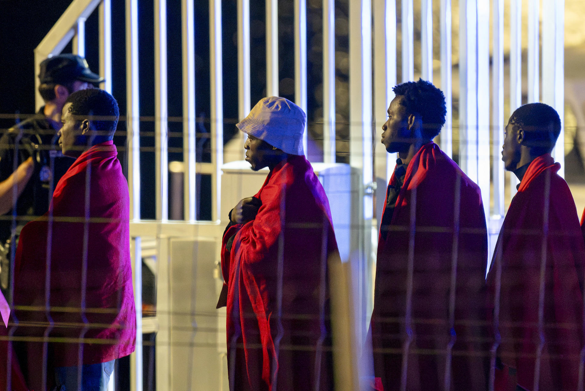 Varios migrantes, del grupo de 55 de origen subsahariano rescatados por la Guardamar Polimnia cuando se encontraban a bordo de una embarcación al nordeste de Lanzarote, a su llegada al puerto de Arrecife en la madrugada de este jueves. EFE/ Adriel Perdomo