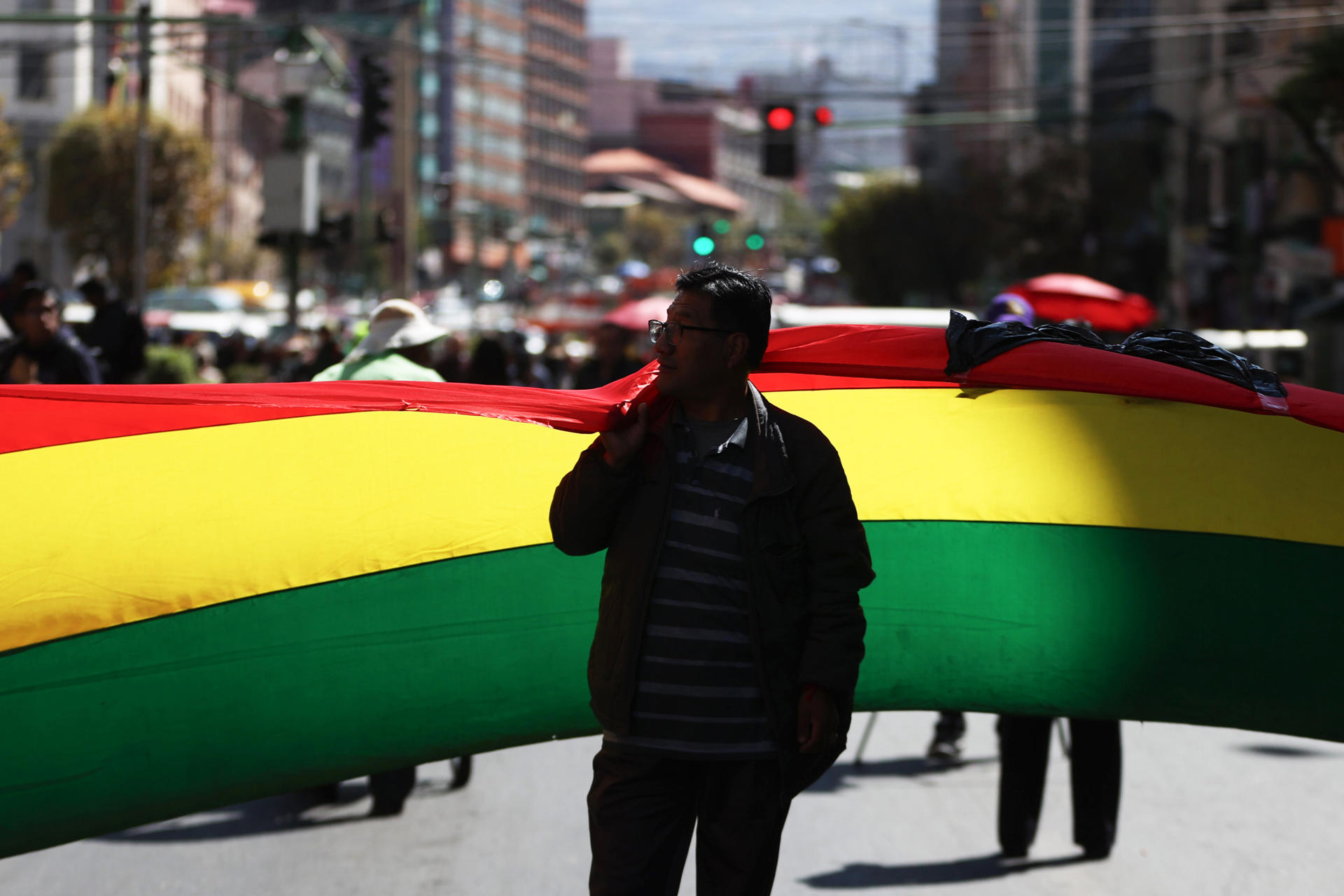 Una persona sostiene una bandera de Bolivia durante una protesta este miércoles, en La Paz (Bolivia). EFE/ Luis Gandarillas
