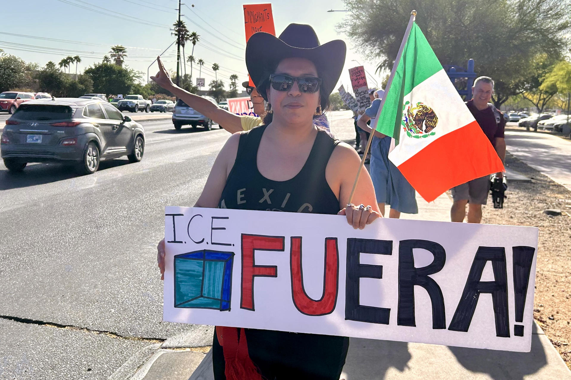 Una mujer sostiene un cartel durante una manifestación este sábado, en Tucson (Estados Unidos). EFE/ María León