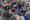 Una mujer junto a su perro disfrazado de Papa es fotografiada por la prensa. Unas 11.000 personas se congregaron este jueves en la plaza de San Pedro del Vaticano y su entorno para ver la segunda fumata del cónclave, que salió negra, por lo que sigue sin haberse elegido un nuevo papa, y se espera que sean muchas más las que se den cita de nuevo en el lugar para la fumata de la tarde. EFE/ Daniel Cáceres
