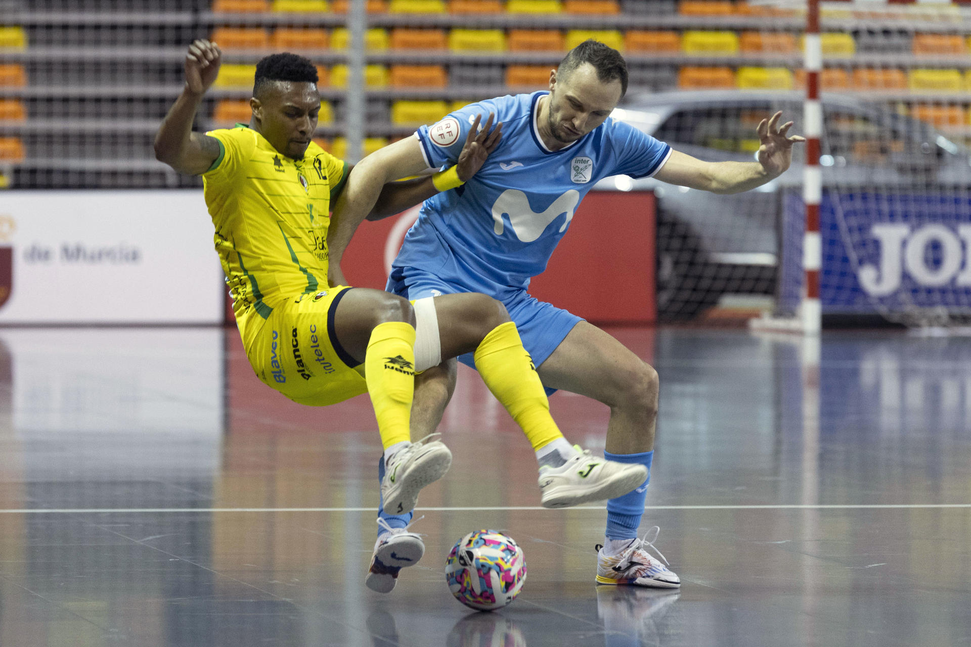 El jugador de Jaén Paraíso Interior Renato (i), intenta controlar el balón ante la presión del jugador de Mivistar Inter Carlos Bartolomé (d), durante el partido de final de Copa del Rey de fútbol sala, este domingo en el Palacio de los Deportes de Cartagena. EFE/Marcial Guillén