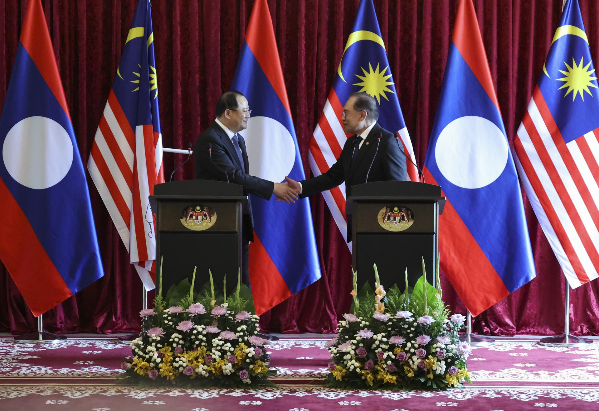 PUTRAJAYA (Malaysia), 25/05/2025.- Malaysian Prime Minister Anwar Ibrahim (R) and Laotian Prime Minister Sonexay Siphandone (L) shake hands during a press conference following their meeting, ahead of the 46th ASEAN Summit, in Putrajaya, Malaysia, 25 May 2025. (Malasia) EFE/EPA/HASNOOR HUSSAIN / POOL