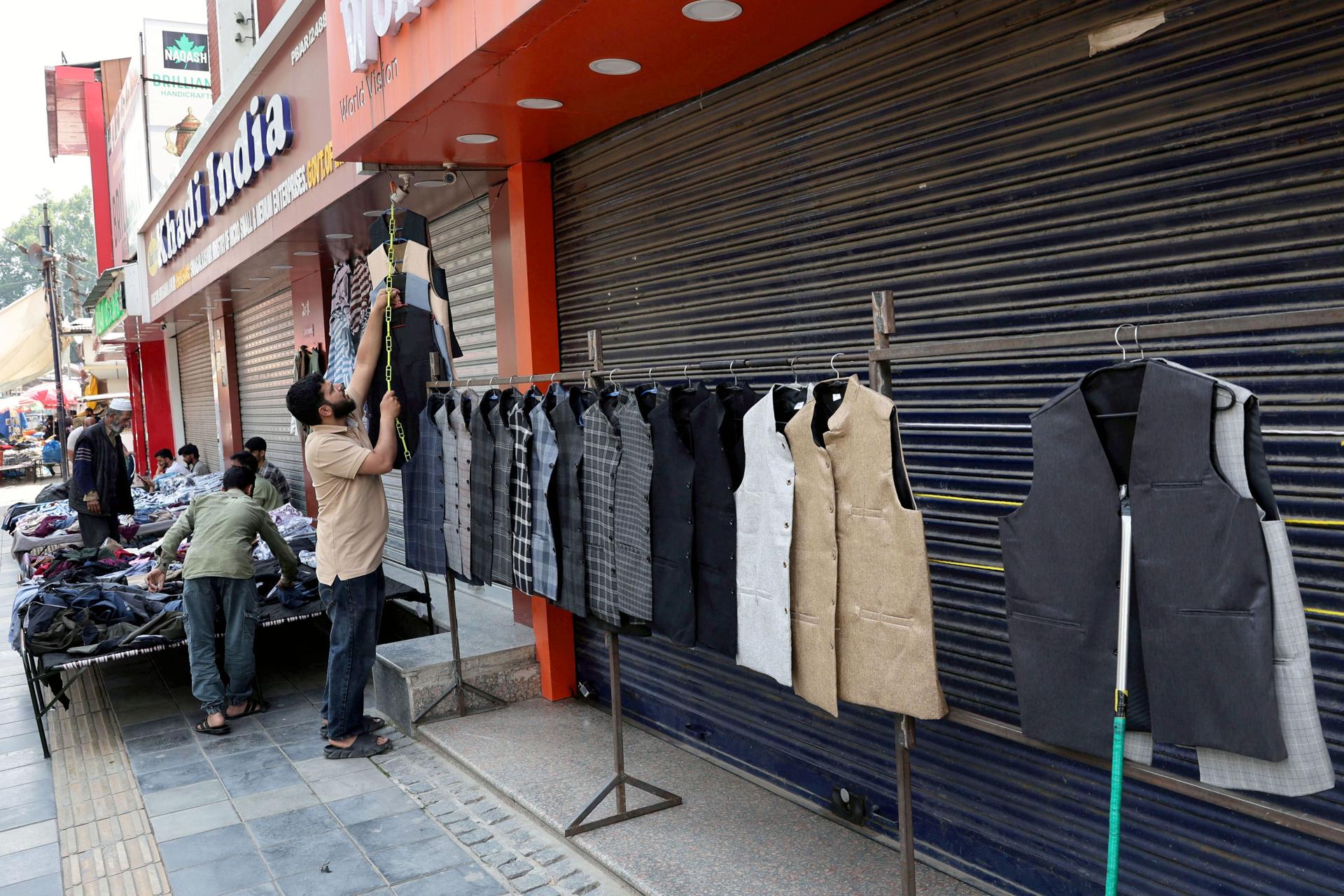 Un vendedor coloca ropa para la venta en un mercado al aire libre en Srinagar, India, el 11 de mayo de 2025, tras el alto el fuego entre India y Pakistán, tras días de escalada militar. EFE/EPA/FAROOQ KHAN