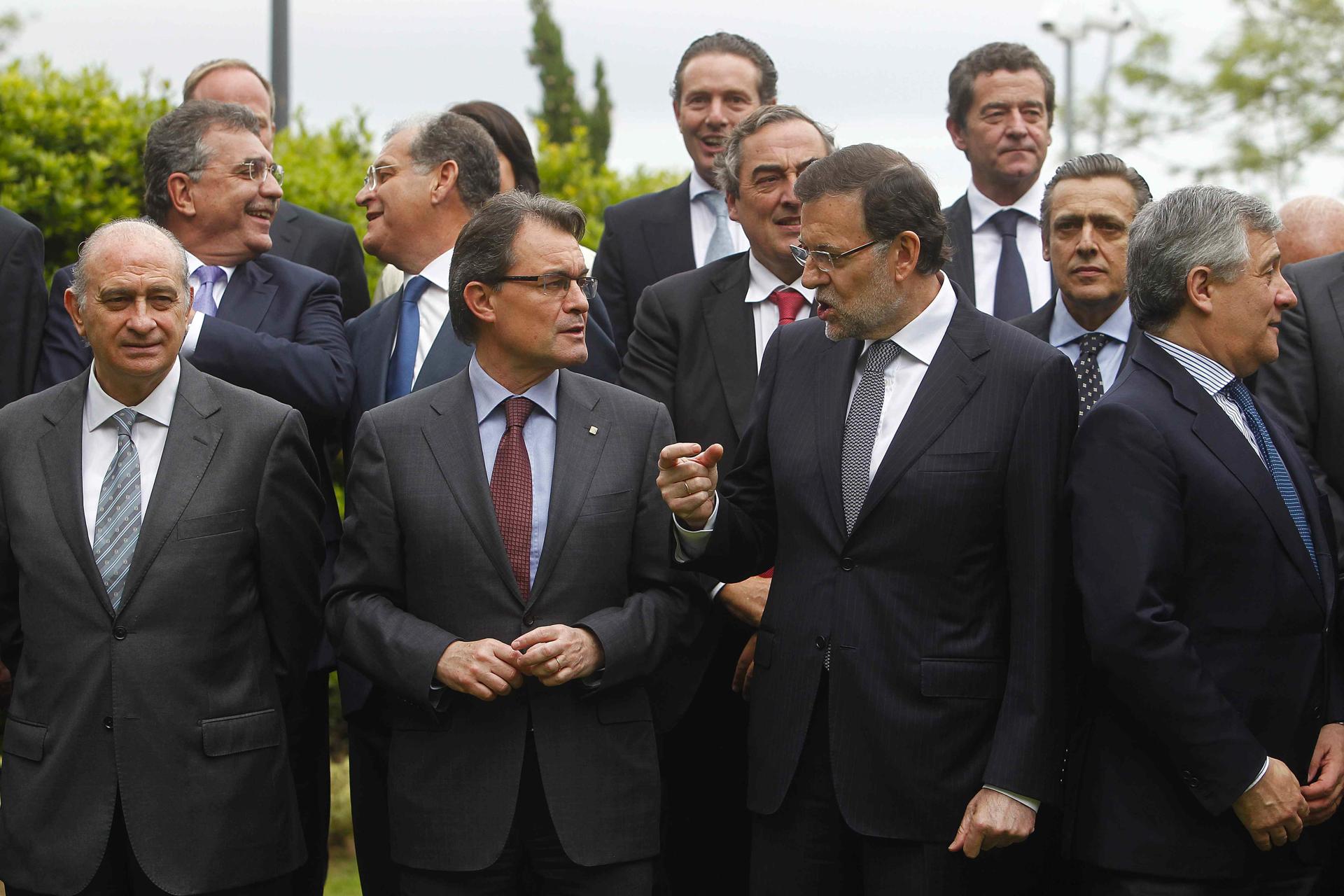 Foto de archivo (10/05/2013) del presidente del Gobierno, Mariano Rajoy (2º d) y el presidente de la Generalitat de Cataluña, Artur Mas,c, y el ministro del Interior, Jorge Fernández Díaz,iz, en la foto de familia previa a la comida con empresarios del sector del automovilismo celebrada en Barcelona. EFE/Marta Pérez
