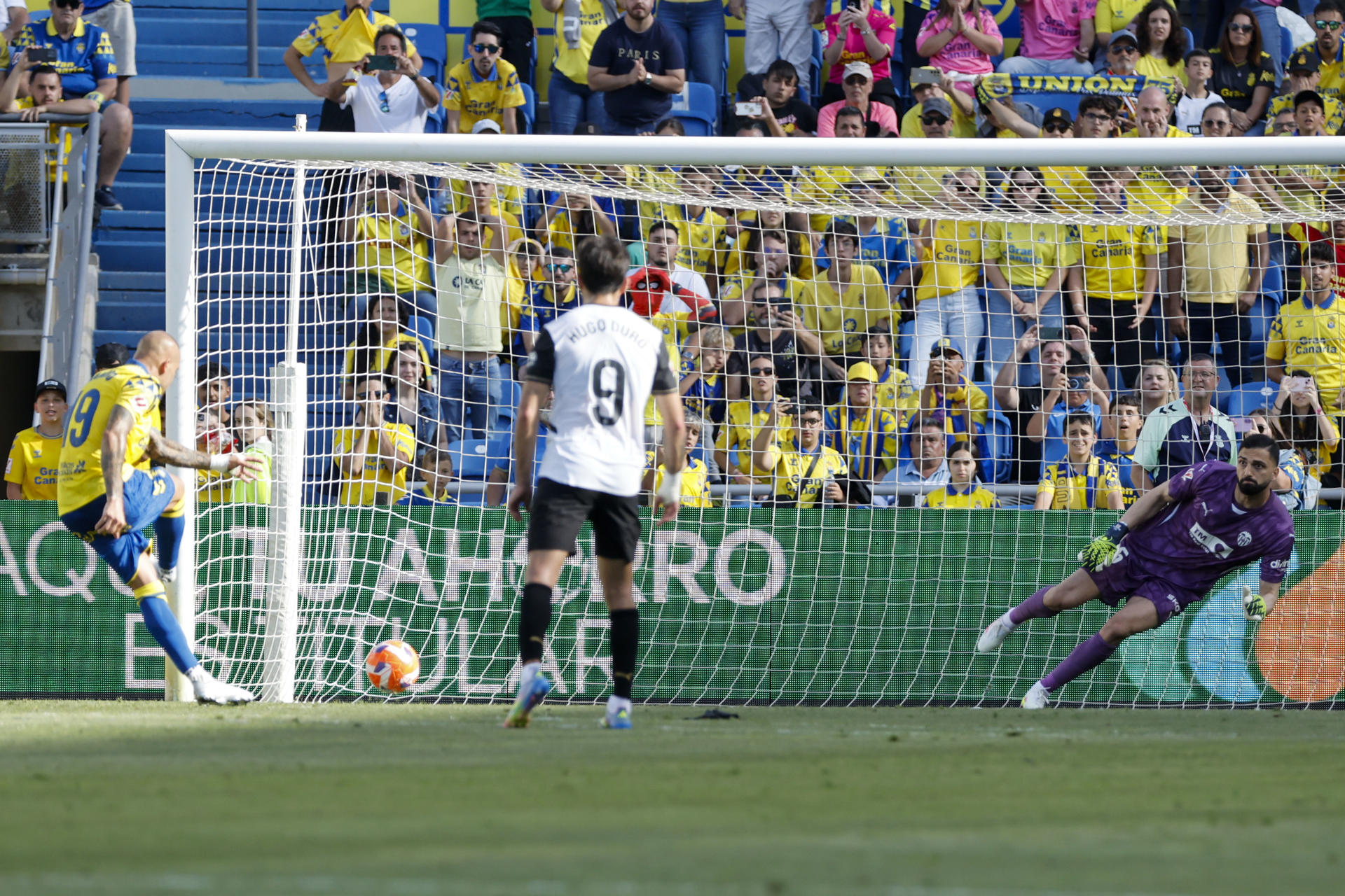 El delantero de Las Palmas Sandro Ramírez (i) marca de penalti ante el Valencia, durante el partido de LaLiga de fútbol que UD Las Palmas y Valencia CF disputan este sábado en el Estadio de Gran Canaria. EFE/Elvira Urquijo