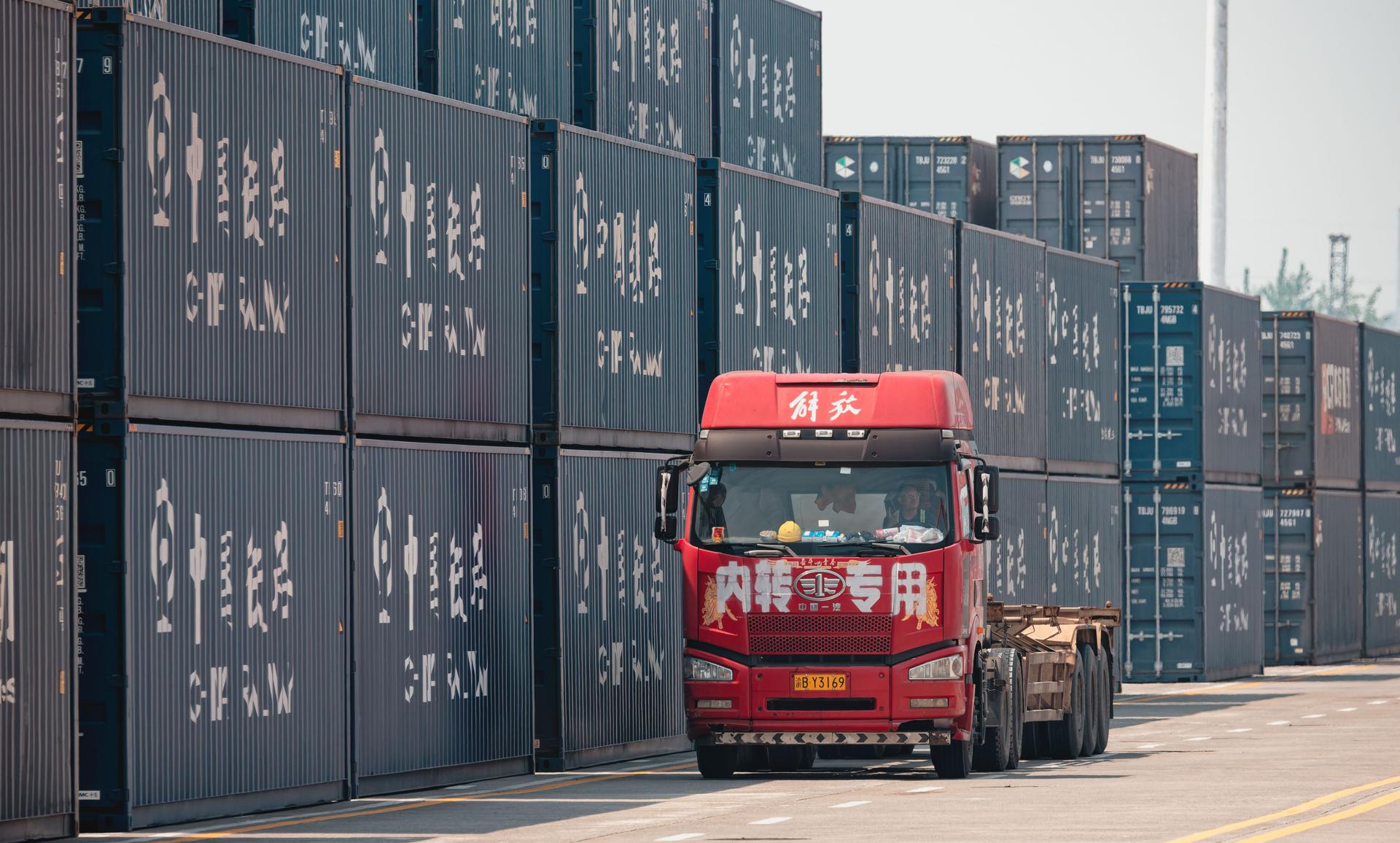 Chongqing (China), 21/05/2025.- A photo taken during an organized press tour shows a truck drive past containers at the Chongqing Railway Container Center Station and New International Land-Sea Trade Corridor Dry Port, in the International Logistics Hub Park in Chongqing, China, 20 May 2025 (issued 21 May 2025). EFE/EPA/ALEX PLAVEVSKI