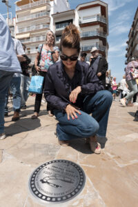 La actriz Emma Vilarasau posa junto a su placa en el paseo Marítimo de Blanes que acoge la inauguración del 'Rincón de la Estrellas', con placas conmemorativas de algunos de los premiados de honor en las dos primeras ediciones del Festival Internacional de Cine de Blanes. EFE/David Borrat