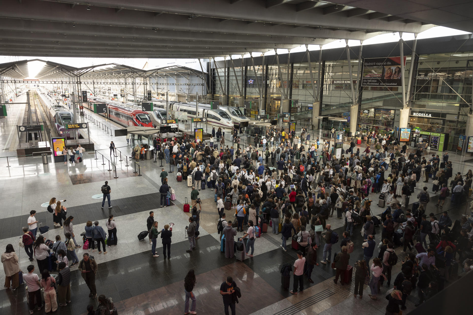 Cientos de viajeros aguardan en los accesos a los andenes de la Estación María Zambrano de Málaga la reanudación del servicio de alta velocidad este lunes tras el robo de cable en cuatro puntos de la provincia de Toledo que ha dejado miles de pasajeros afectados. EFE/Jorge Zapata