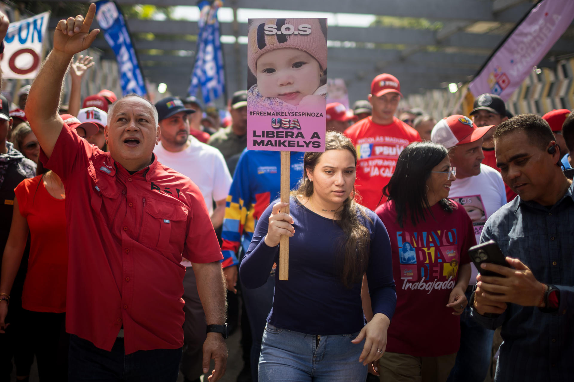 El ministro de interior y justicia, Diosdado Cabello (i), camina junto a Yorely Bernal (c), madre de Maikelys Espinoza, durante una manifestación este jueves, en el marco del Día Internacional del Trabajo, en Caracas (Venezuela). EFE/ Miguel Gutiérrez