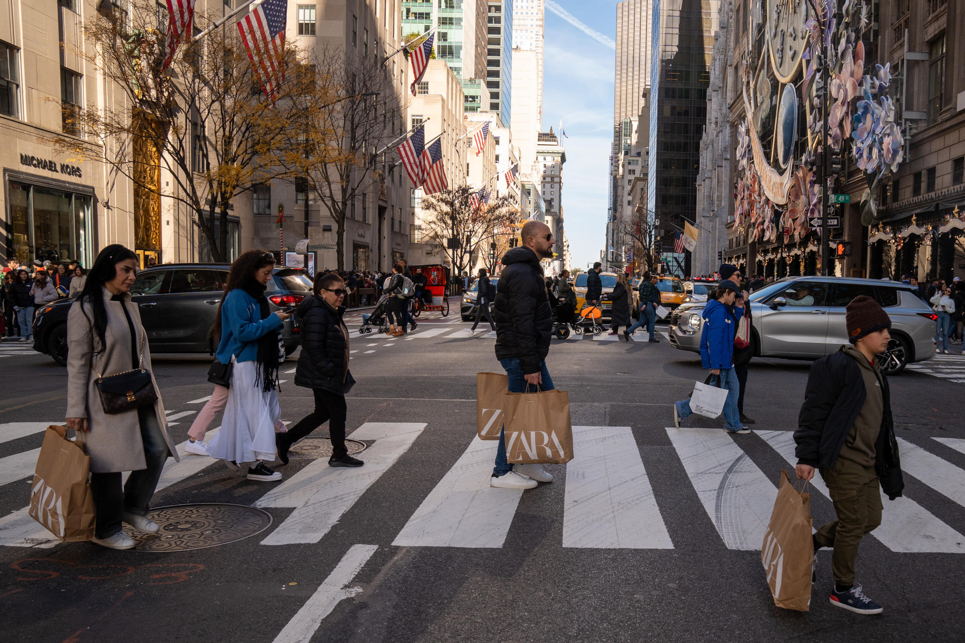 Varias personas caminan con bolsas de tiendas luego de hacer compras en Nueva York (Estados Unidos), en una fotografía de archivo. EFE/ Angel Colmenares