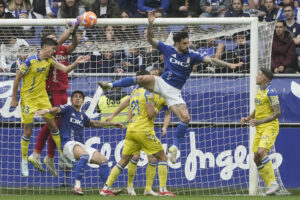 El guardameta del Cádiz, Victor Aznar (2i), intenta despejar el balón durante el encuentro correspondiente a la última jornada de la Liga Hypermotion que disputan hoy domingo Real Oviedo y Cádiz en el estadio Carlos Tartiere de la capital asturiana. EFE/Paco Paredes.