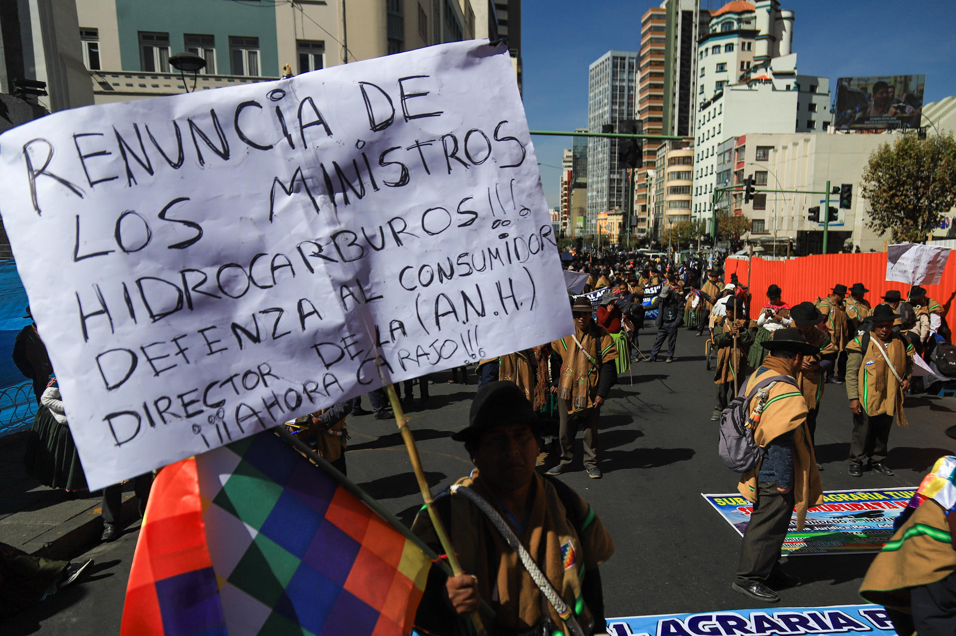 Un indígena aimara sostiene un cartel durante una protesta este lunes, en La Paz (Bolivia). Miles de campesinos y comerciantes marcharon por separado en la ciudad boliviana de La Paz para exigir al Gobierno de Luis Arce salidas "inmediatas" a la situación económica que afronta el país por la inflación, la falta de dólares y el desabastecimiento de combustibles. EFE/ Gabriel Márquez
