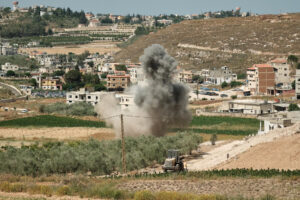 Varios desminadores trabajan para limpiar un terreno agrícola de los remanentes de un almacén de armas perteneciente al grupo chií libanés Hizbulá que fue bombardeado por Israel durante la guerra del pasado año. EFE/Edgar Gutiérrez