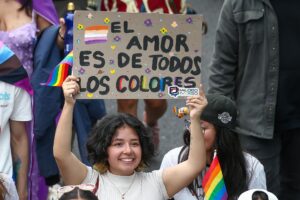 Una integrante de la comunidad LGBT+ sostiene un cartel en la Marcha del Orgullo este sábado, en Quito (Ecuador). EFE/ José Jácome
