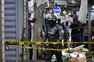 Un integrante de la policía observa este miércoles, los daños causados por una explosión registrada la noche anterior en la zona comercial de La Bahía, en Guayaquil (Ecuador). EFE/ Jonathan Miranda