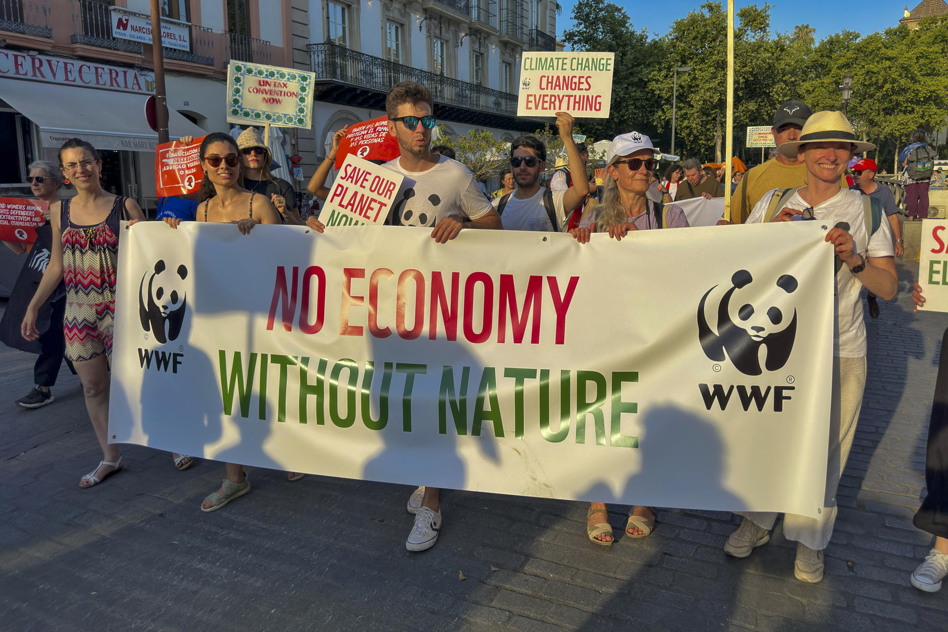 Cientos de personas han participado la tarde de este domingo en Sevilla en una manifestación para reclamar "justicia económica global", con modelos económicos de financiación justos, democráticos y alineados con los derechos humanos y los límites del planeta. EFE/ David Arjona