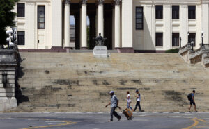 Personas caminan frente a la entrada de la Universidad de La Habana este sábado, en La Habana (Cuba). EFE/ Ernesto Mastrascusa