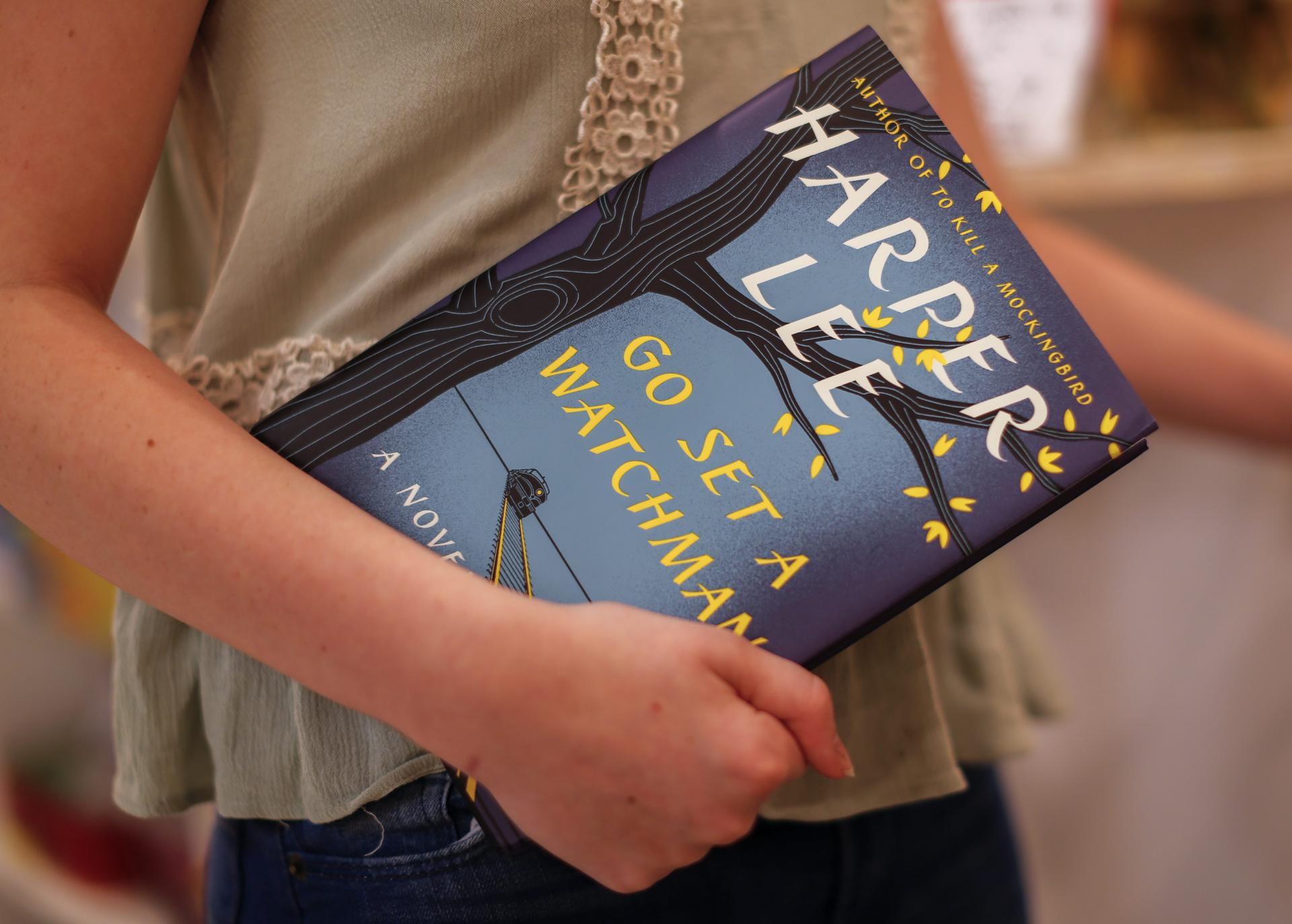 Imagen de archivo de una mujer con un ejemplar de la novela de Harper Lee "Ve y pon un centinela" publicada en 2015. EFE/ERIK S. LESSER