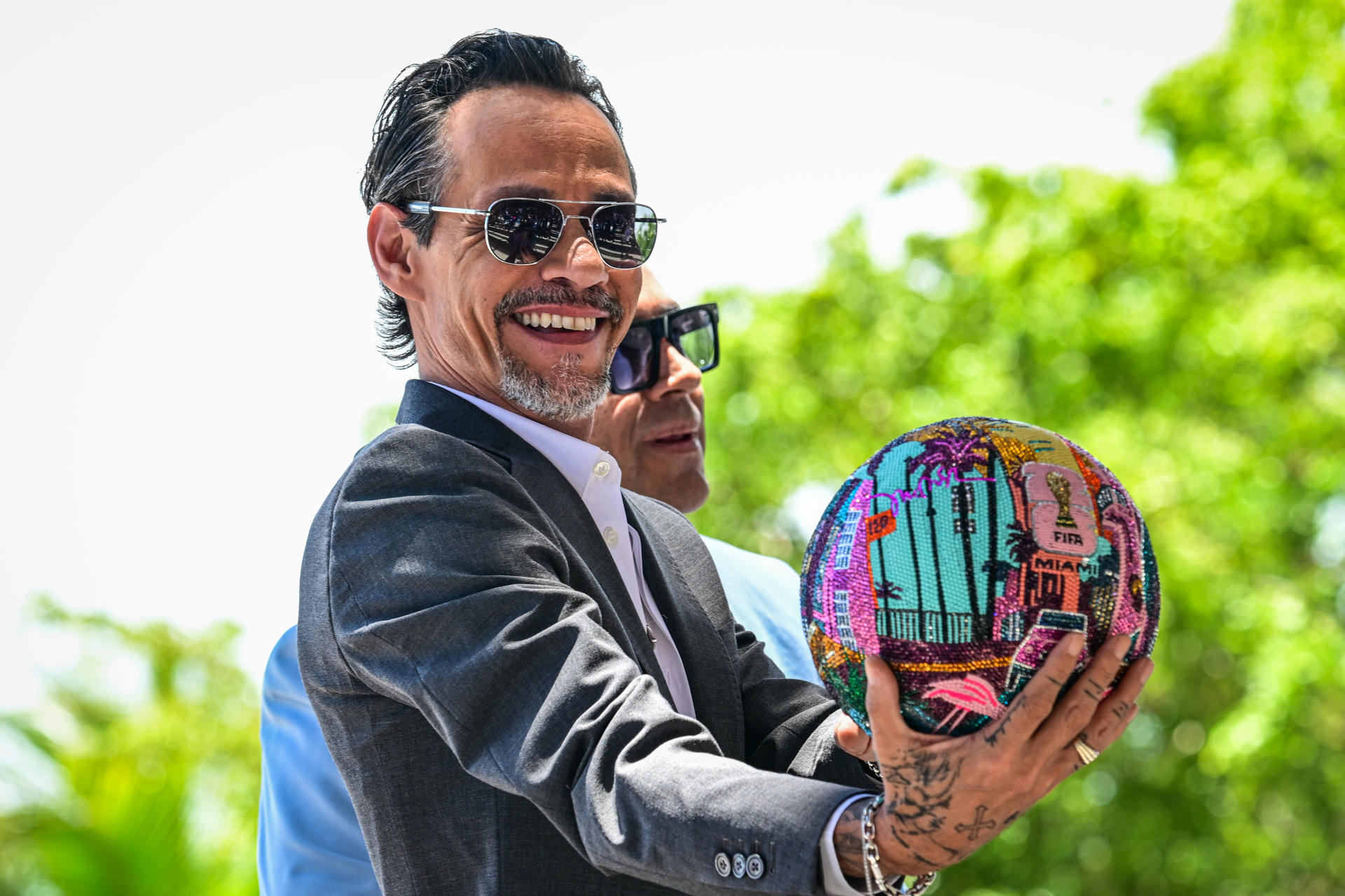 El cantante estadounidense Marc Anthony sostiene el balón realizado por el artista colombiano Mr. Bling, durante el lanzamiento simbólico de la cuenta regresiva oficial para la Copa Mundial de la FIFA 2026, en el exterior del Museo de Arte Pérez, este miércoles en Miami (Estados Unidos). EFE/ Giorgio Viera