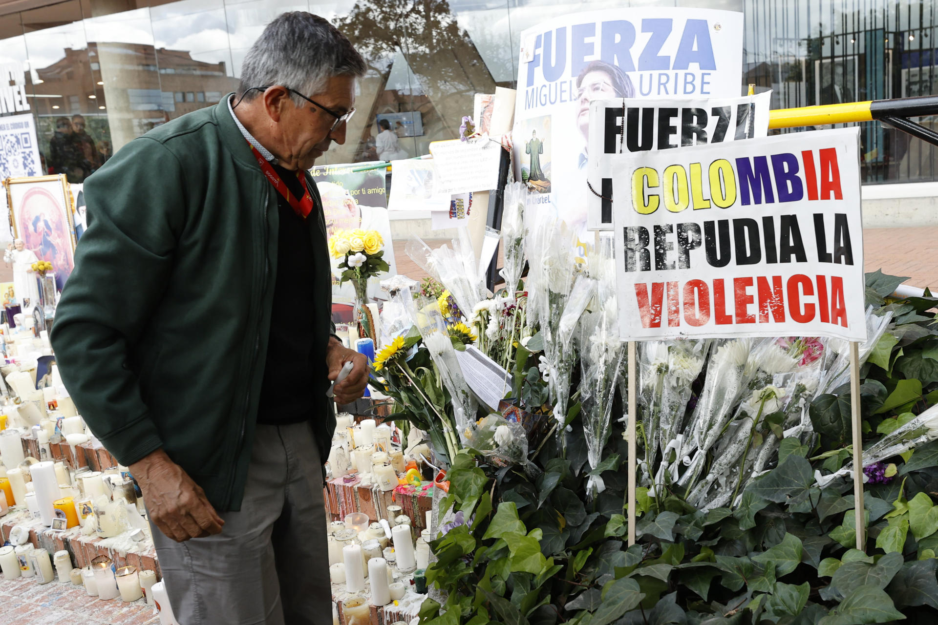 Un hombre observa un altar por la salud del senador Miguel Uribe Turbay frente a la Clínica Fundación Santa Fe de Bogotá (Colombia). EFE/ Mauricio Dueñas Castañeda