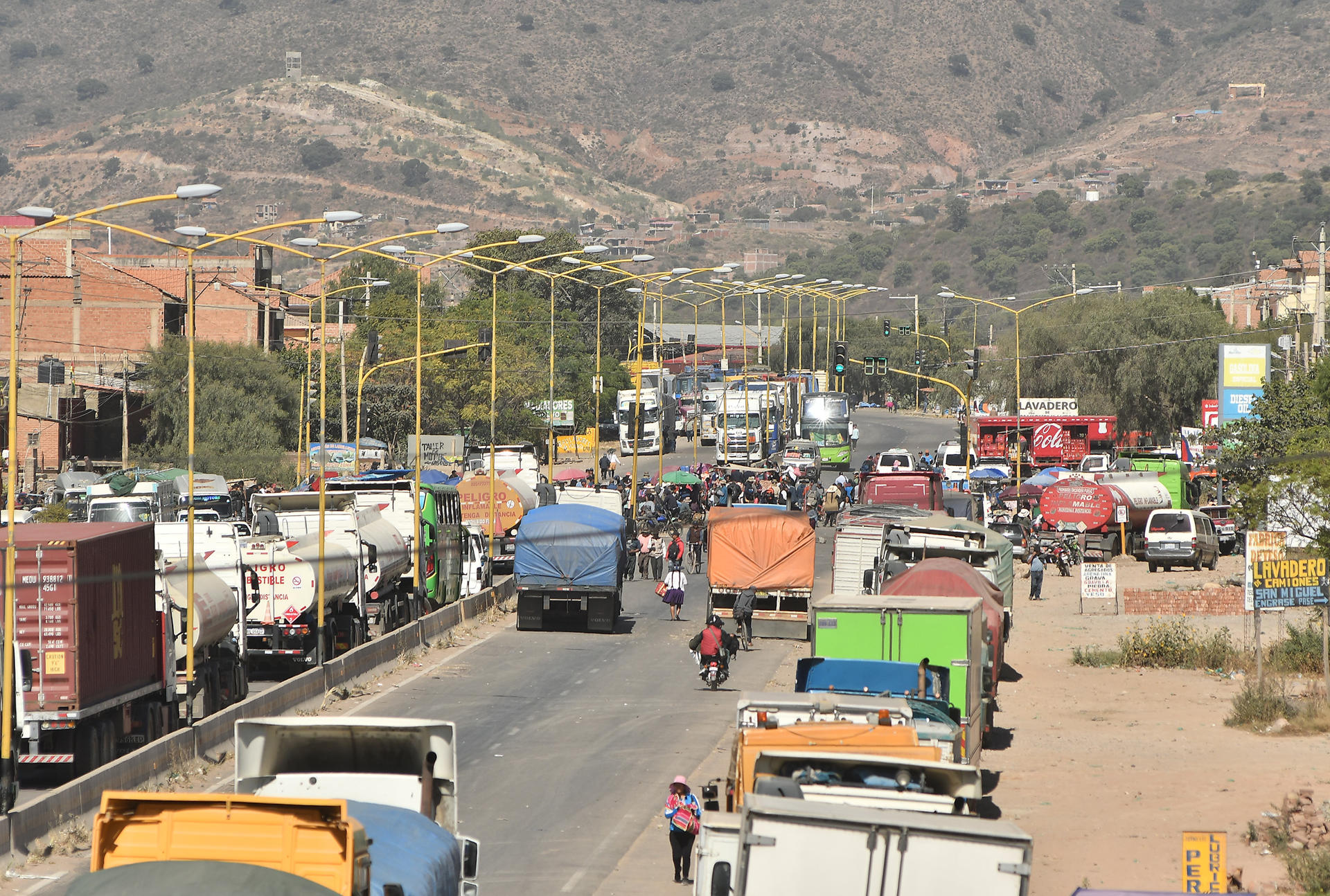 Camiones esperan en una carretera tras un bloqueo realizado por seguidores del exmandatario Evo Morales este lunes, en Sipe Sipe en la región de Cochabamba (Bolivia). EFE/ Jorge Abrego