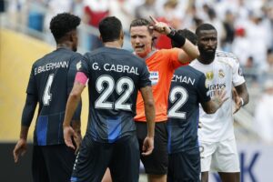 Gustavo Cabral, capitán de Pachuca, habla con el árbitro durante el partido del Mundial de Clubes en Charlotte. Antonio Rudiger (al fondo), jugador del Real Madrid, lo acusó de racismo. EFE/EPA/ERIK S. LESSER