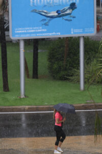Una mujer se protege de la lluvia este jueves en València. EFE/ Kai Forsterling