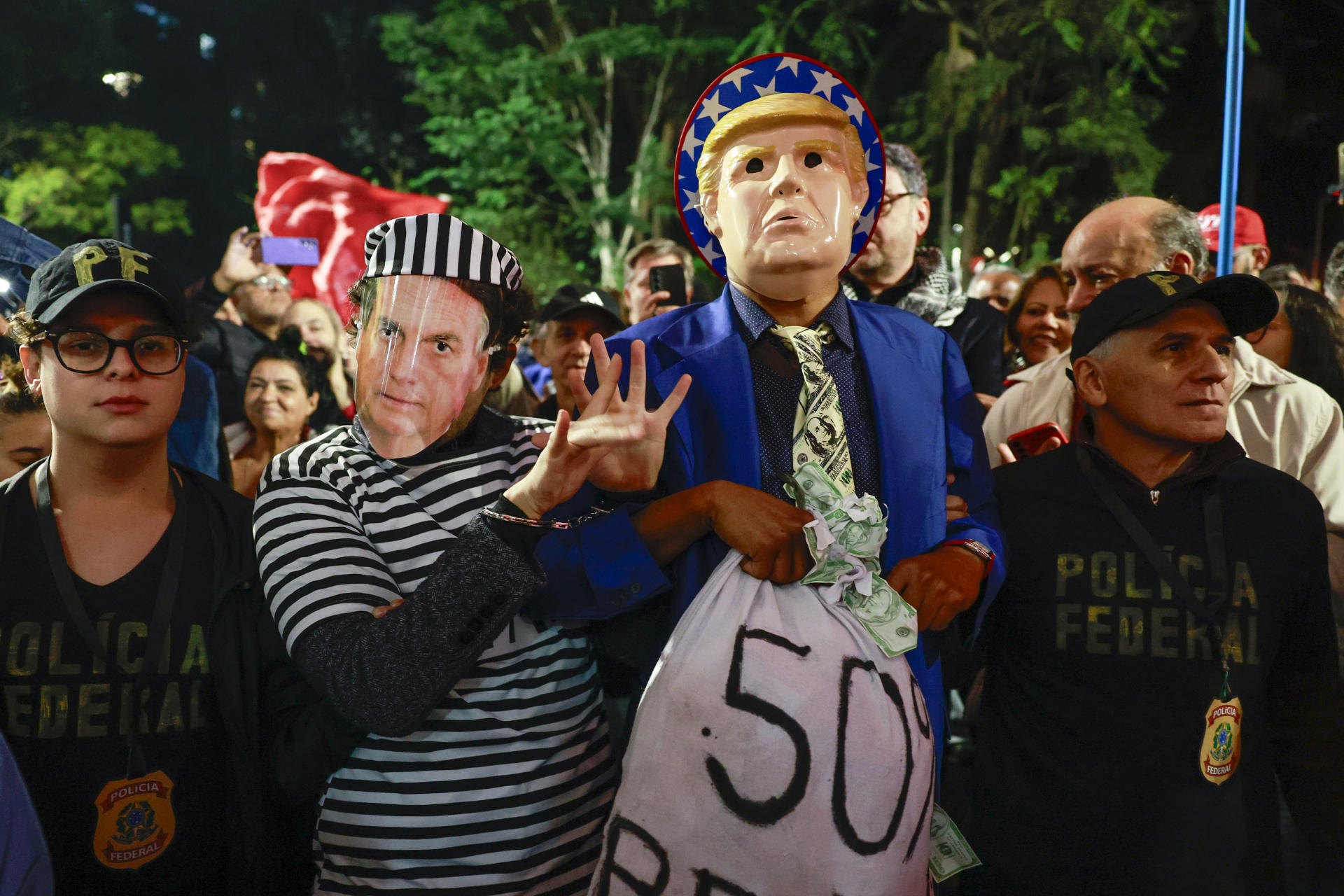 Integrantes de movimientos sociales sostienen un cartel con la imagen del presidente de Estados Unidos, Donald Trump, durante una manifestación en defensa del Gobierno de Luiz Inácio Lula da Silva este jueves, en Sao Paulo (Brasil). EFE/ Sebastiao Moreira