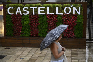 Una mujer cruza, este miércoles, por una calle de la ciudad de Castellón bajo una intensa lluvia. EFE/Andreu Esteban