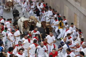 Los mozos corren ante los toros de la ganadería Jandilla durante el quinto encierro de los Sanfermines este viernes en Pamplona. EFE/Villar López