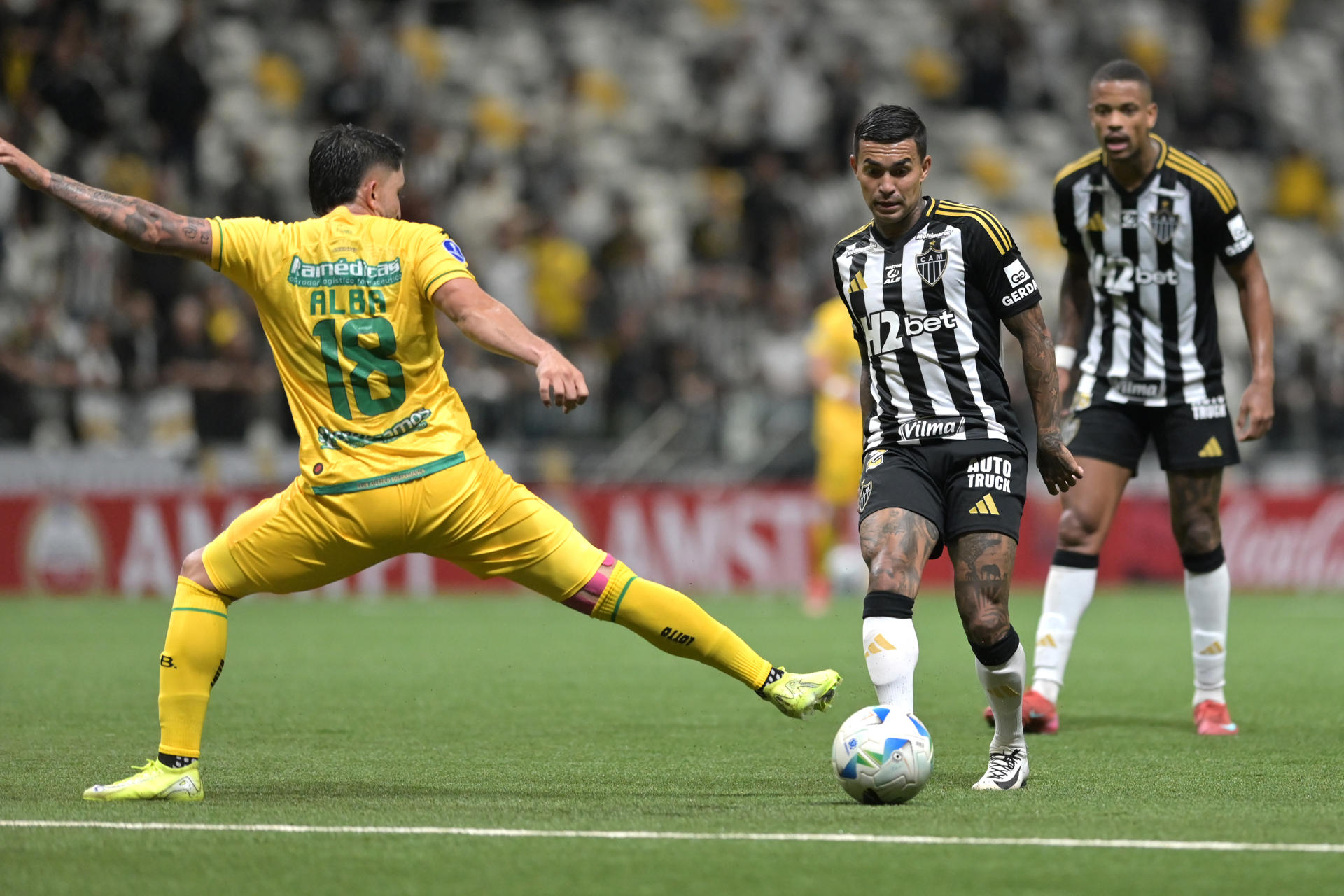 Dudu (d), del Mineiro, disputa el balón con Israel Alba, de Bucaramanga. EFE/Joao Guilherme